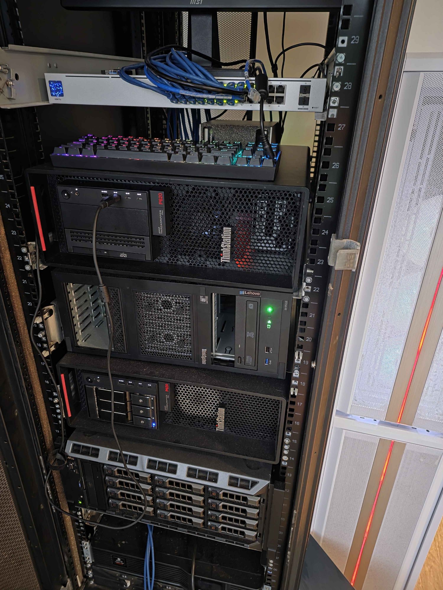 Inside the rack: the network switch, patched cabling and the machines below it